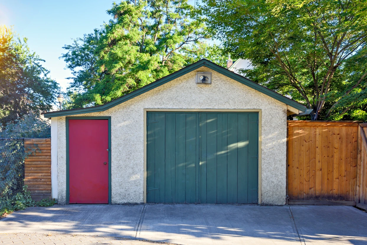 Old garage and entrance door from backstreet side of residential house
