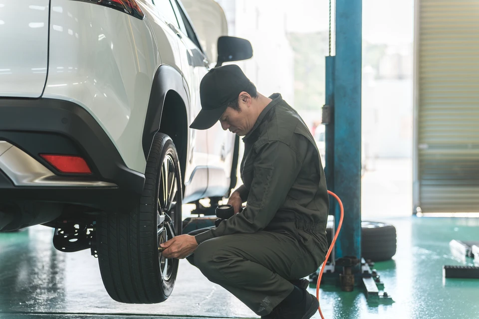 Scène extérieure désertique avec trois jeunes adultes célébrant près d'un pickup vintage bleu